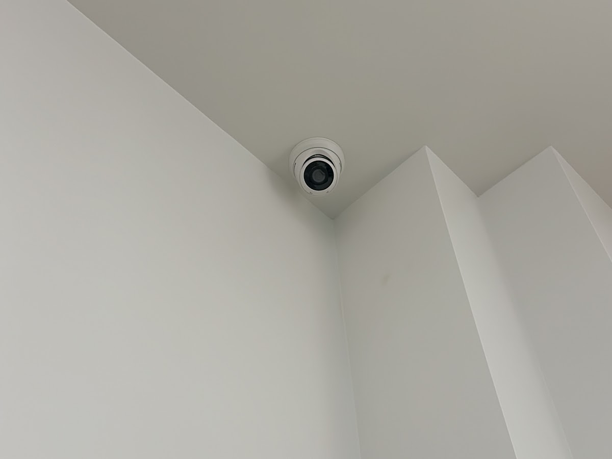 Interior dome security camera installed on a stairwell ceiling