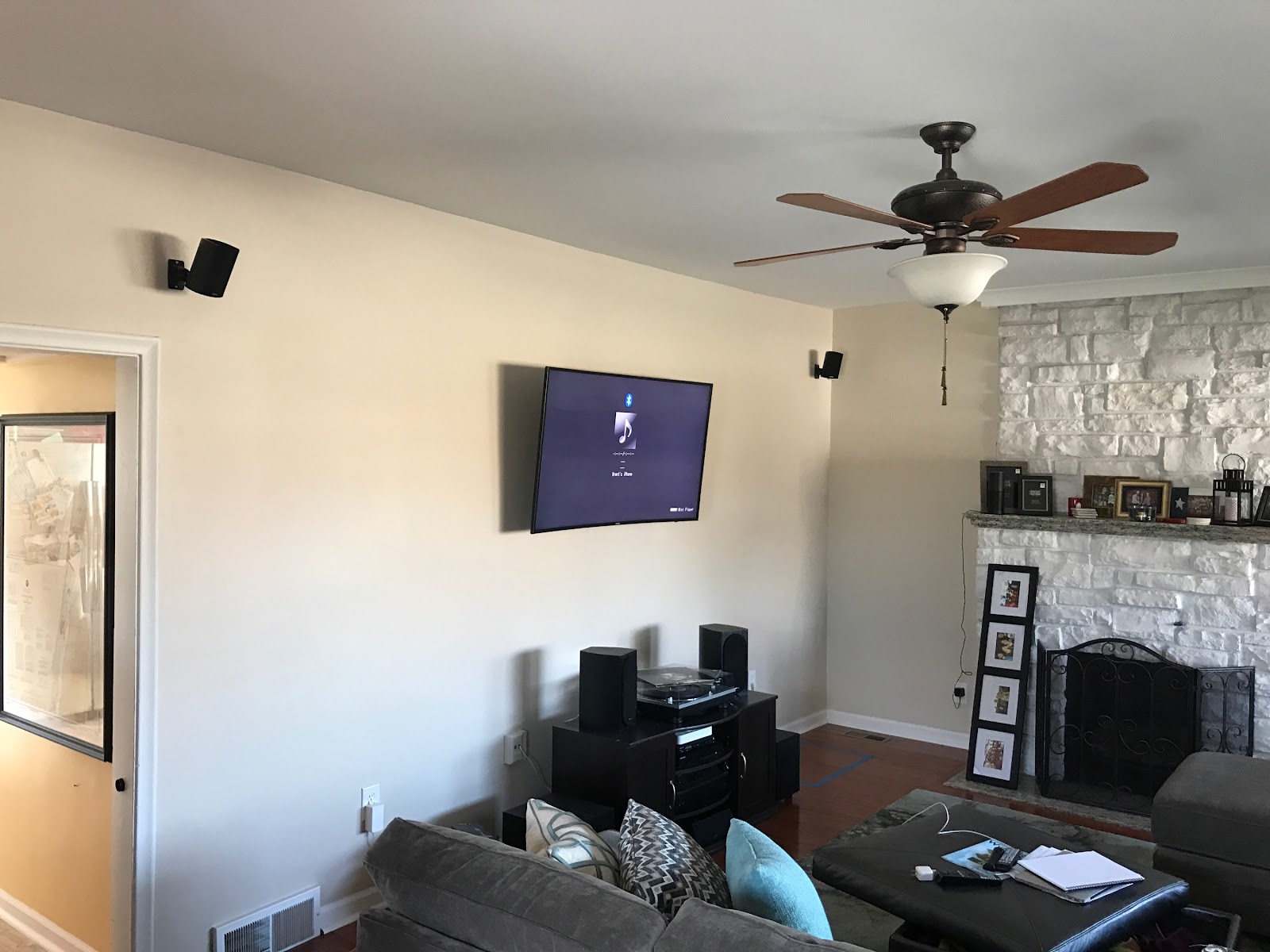 Home theater room with mounted TV and surround sound speakers installed by Rtechwork