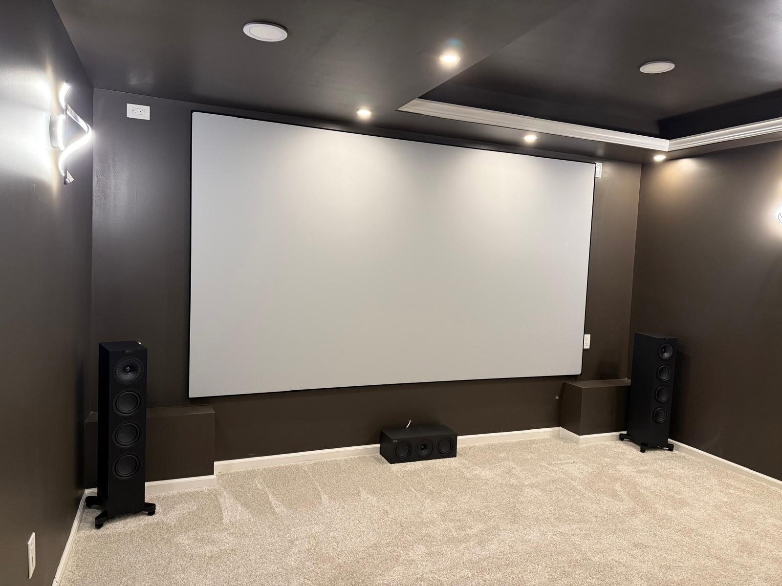 Dedicated home theater room with projector screen installed by Rtechwork