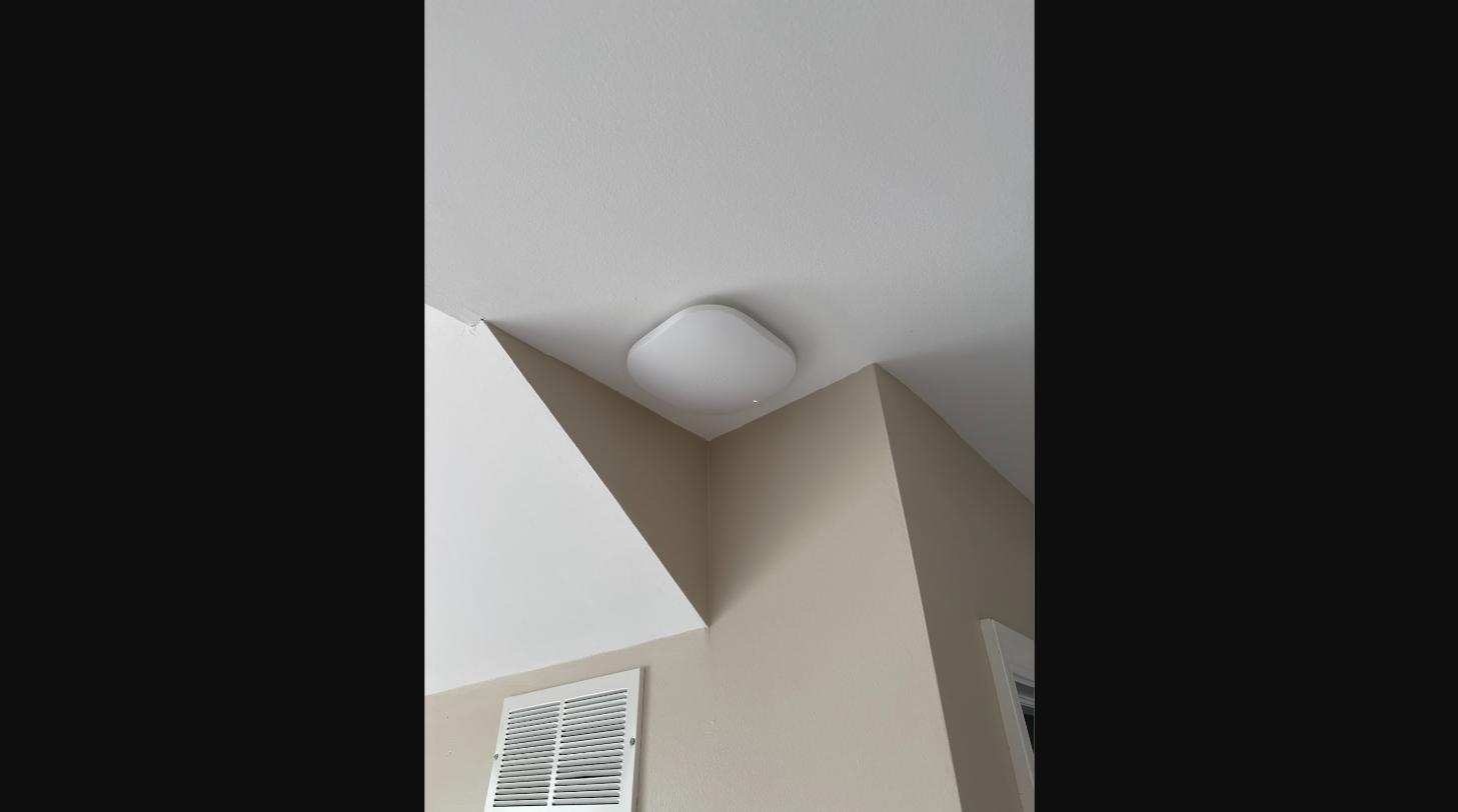 Ceiling-mounted mesh Wi-Fi access point installed as part of a whole-home network wiring upgrade