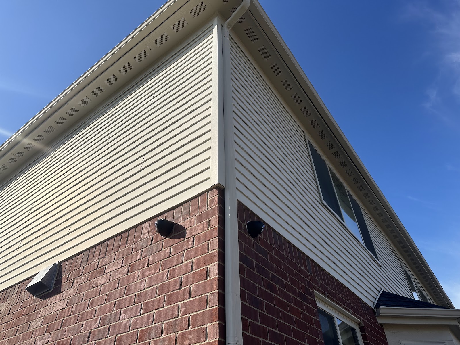 Exterior security camera installed on a brick home corner by Rtechwork in Metro Detroit