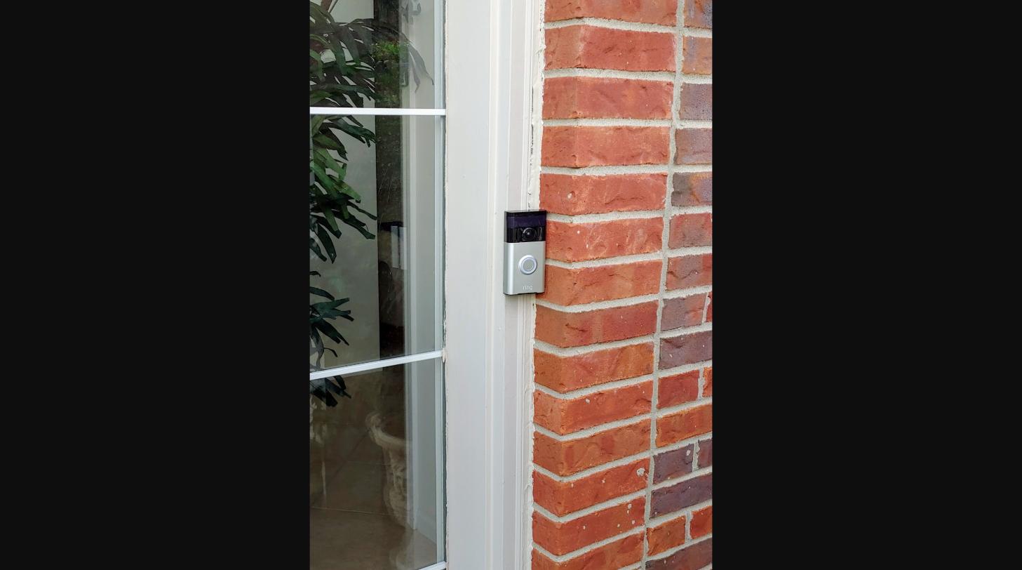 Smart video doorbell installed on a brick entryway at a Metro Detroit home